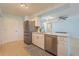 Open concept kitchen with stainless steel appliances, a central island, and a view into the living area at 18836 Summersong Dr, Hudson, FL 34667