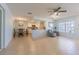 Open-concept living space boasts tile floors, ceiling fan, and views into the kitchen and dining area at 18836 Summersong Dr, Hudson, FL 34667
