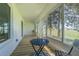 Enclosed patio with wood-look flooring and views of the yard through multiple windows, perfect for relaxation at 18836 Summersong Dr, Hudson, FL 34667