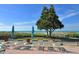 Outdoor lounge area with beach chairs and umbrellas overlooking the ocean at 2055 Gulf Of Mexico Dr # G2-213, Longboat Key, FL 34228