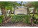 Inviting sign for Country Club Condominiums Association III surrounded by lush landscaping and tropical palm trees at 232 Nina Way # 232, Oldsmar, FL 34677