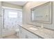 Bathroom features a large mirror, white vanity with granite countertop, and a shower/tub combo at 2412 Arborwood Dr, Valrico, FL 33596
