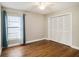 Bedroom features hardwood floors, ceiling fan, large closet, and window providing natural light at 2412 Arborwood Dr, Valrico, FL 33596