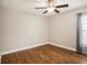 Bedroom featuring wood floors, a ceiling fan, and a window at 2412 Arborwood Dr, Valrico, FL 33596