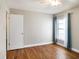Bedroom features hardwood floors, ceiling fan, and a window providing natural light at 2412 Arborwood Dr, Valrico, FL 33596