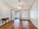 Bright living room showcasing wood floors, a ceiling fan, and sliding glass door to the pool area at 2412 Arborwood Dr, Valrico, FL 33596
