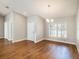 Open-concept living room with hardwood floors, a front door, and bright natural light at 2412 Arborwood Dr, Valrico, FL 33596