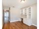 Well-lit office featuring wood floors and a built-in desk with shelving at 2412 Arborwood Dr, Valrico, FL 33596