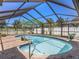 Private pool with screened enclosure and landscaped patio at 2412 Arborwood Dr, Valrico, FL 33596