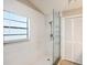 Bathroom shower featuring white tiles and a glass door at 2412 Arborwood Dr, Valrico, FL 33596
