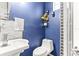 Stylish bathroom with blue walls, decorative floral arrangement, and a modern white sink at 2759 Conch Hollow Dr, Brandon, FL 33511