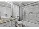 Well-lit bathroom with a modern sink and a glass-enclosed shower-bathtub combination at 2759 Conch Hollow Dr, Brandon, FL 33511