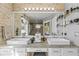 Bright bathroom featuring dual sinks, granite countertop, and a large well lit mirror at 2759 Conch Hollow Dr, Brandon, FL 33511