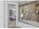 Elegant bathroom with a glass enclosed shower and bathtub, adjacent to the primary bedroom at 2759 Conch Hollow Dr, Brandon, FL 33511