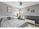 Cozy bedroom with a ceiling fan, desk, and a window allowing natural light at 2759 Conch Hollow Dr, Brandon, FL 33511