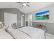 Primary bedroom suite with television, ceiling fan, seating area, and ensuite bathroom at 2759 Conch Hollow Dr, Brandon, FL 33511