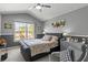 Bright bedroom with large window, ceiling fan, sitting area, and tasteful decor at 2759 Conch Hollow Dr, Brandon, FL 33511