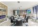 Spacious dining room featuring an electric fireplace, modern chandelier, and access to a living area at 2759 Conch Hollow Dr, Brandon, FL 33511