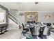 Elegant dining room with stylish decor, modern lighting, and an adjacent open kitchen area at 2759 Conch Hollow Dr, Brandon, FL 33511
