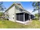 Exterior view of this townhome's screened lanai and lush green lawn at 2759 Conch Hollow Dr, Brandon, FL 33511