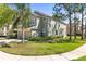 Landscaped townhome featuring a two-car garage and lush green lawn, offering curb appeal at 2759 Conch Hollow Dr, Brandon, FL 33511