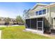 View of this townhome's screened lanai and verdant green grass at 2759 Conch Hollow Dr, Brandon, FL 33511