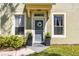 Charming entryway featuring a stylish door, potted plants, and well-maintained landscaping at 2759 Conch Hollow Dr, Brandon, FL 33511