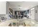 Kitchen sink in a modern kitchen overlooking the dining and living areas with a stone fireplace at 2759 Conch Hollow Dr, Brandon, FL 33511