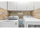 Well-organized laundry room featuring modern washer and dryer units and overhead cabinetry at 2759 Conch Hollow Dr, Brandon, FL 33511