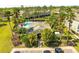 Aerial shot of community pool and clubhouse surrounded by lush landscaping and palm trees at 2759 Conch Hollow Dr, Brandon, FL 33511