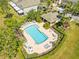 Aerial view of community pool surrounded by palm trees with plenty of lounge seating at 2759 Conch Hollow Dr, Brandon, FL 33511