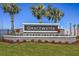 Entrance sign for the Gracewater community, surrounded by lush landscaping and mature palm trees at 2801 Marrakesh Ln, Sarasota, FL 34234