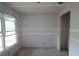 Unfinished room featuring fresh drywall, a modern window, and an open doorway ready for customization at 2801 Marrakesh Ln, Sarasota, FL 34234