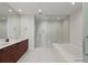Luxury bathroom with double vanity, soaking tub, and separate glass-enclosed shower at 301 1St S St # 3207, St Petersburg, FL 33701