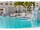 A luxurious pool featuring in-water lounge areas, palm trees, and cascading waterfalls at 301 1St S St # 3207, St Petersburg, FL 33701