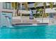 Inviting pool sunshelf area with a waterfall feature near lounge seating and palm trees at 301 1St S St # 3207, St Petersburg, FL 33701