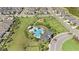 Aerial view showcases community pool with splash pad, playground, and surrounding landscaped areas at 30364 Marquette Ave, Wesley Chapel, FL 33545
