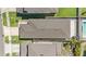 A high-angle aerial view of a single-Gathering home featuring a well-maintained roof and a manicured lawn at 30364 Marquette Ave, Wesley Chapel, FL 33545