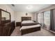 Primary bedroom featuring wood furniture, carpet flooring, and bright natural lighting at 30364 Marquette Ave, Wesley Chapel, FL 33545