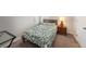 Cozy bedroom featuring a floral patterned duvet, a wooden headboard, and a wood nightstand at 30364 Marquette Ave, Wesley Chapel, FL 33545