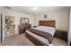 Primary bedroom featuring wood furniture, carpet flooring, and bright natural lighting at 30364 Marquette Ave, Wesley Chapel, FL 33545