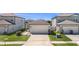 Well-maintained home featuring a two-car garage, landscaping, and long driveway at 30364 Marquette Ave, Wesley Chapel, FL 33545