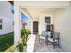 Inviting front porch with decorative chairs and plants at 30364 Marquette Ave, Wesley Chapel, FL 33545