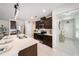 A kitchen area featuring stainless steel appliances, an island, and an open view to the front door at 30364 Marquette Ave, Wesley Chapel, FL 33545