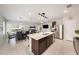 An open concept kitchen features an island with a quartz countertop and stainless steel appliances at 30364 Marquette Ave, Wesley Chapel, FL 33545