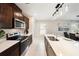 An open concept kitchen shows stainless steel appliances and a kitchen island with a sink at 30364 Marquette Ave, Wesley Chapel, FL 33545