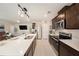 An open concept kitchen features an island with a quartz countertop and stainless steel appliances at 30364 Marquette Ave, Wesley Chapel, FL 33545