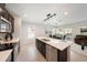 An open concept kitchen shows a view of the dining area, living room, and stainless steel appliances at 30364 Marquette Ave, Wesley Chapel, FL 33545