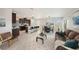Bright and spacious living room with modern furniture, connecting the kitchen and dining area at 30364 Marquette Ave, Wesley Chapel, FL 33545
