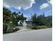 Charming home with a brick walkway, bright red front door and lush landscaping at 3204 W Clinton St, Tampa, FL 33614